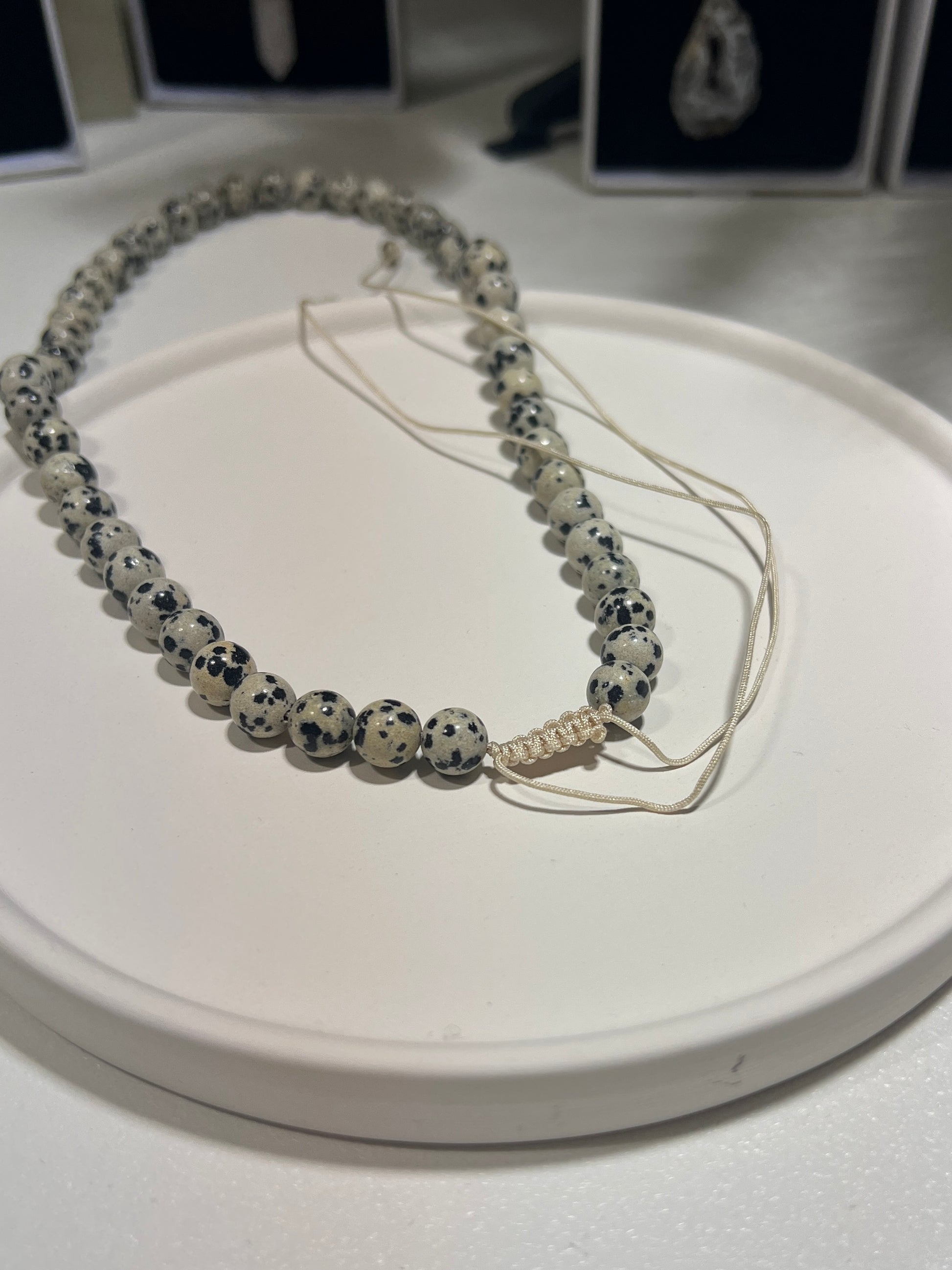 Necklace with dalmatian Jasper beads on a white surface