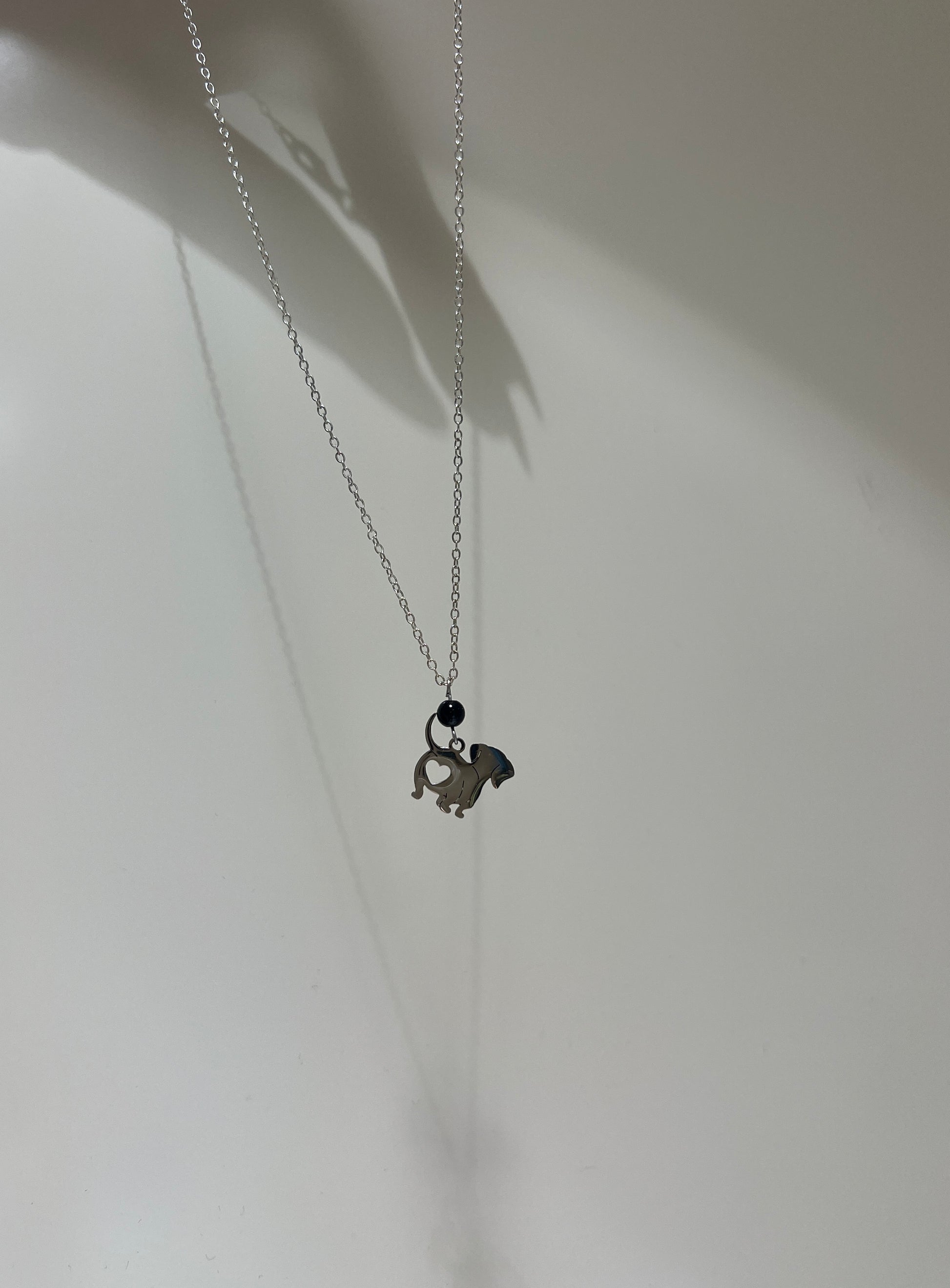 Necklace with a small pendant on a plain background