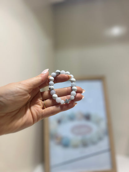 Hand holding a beaded bracelet with a blurred background