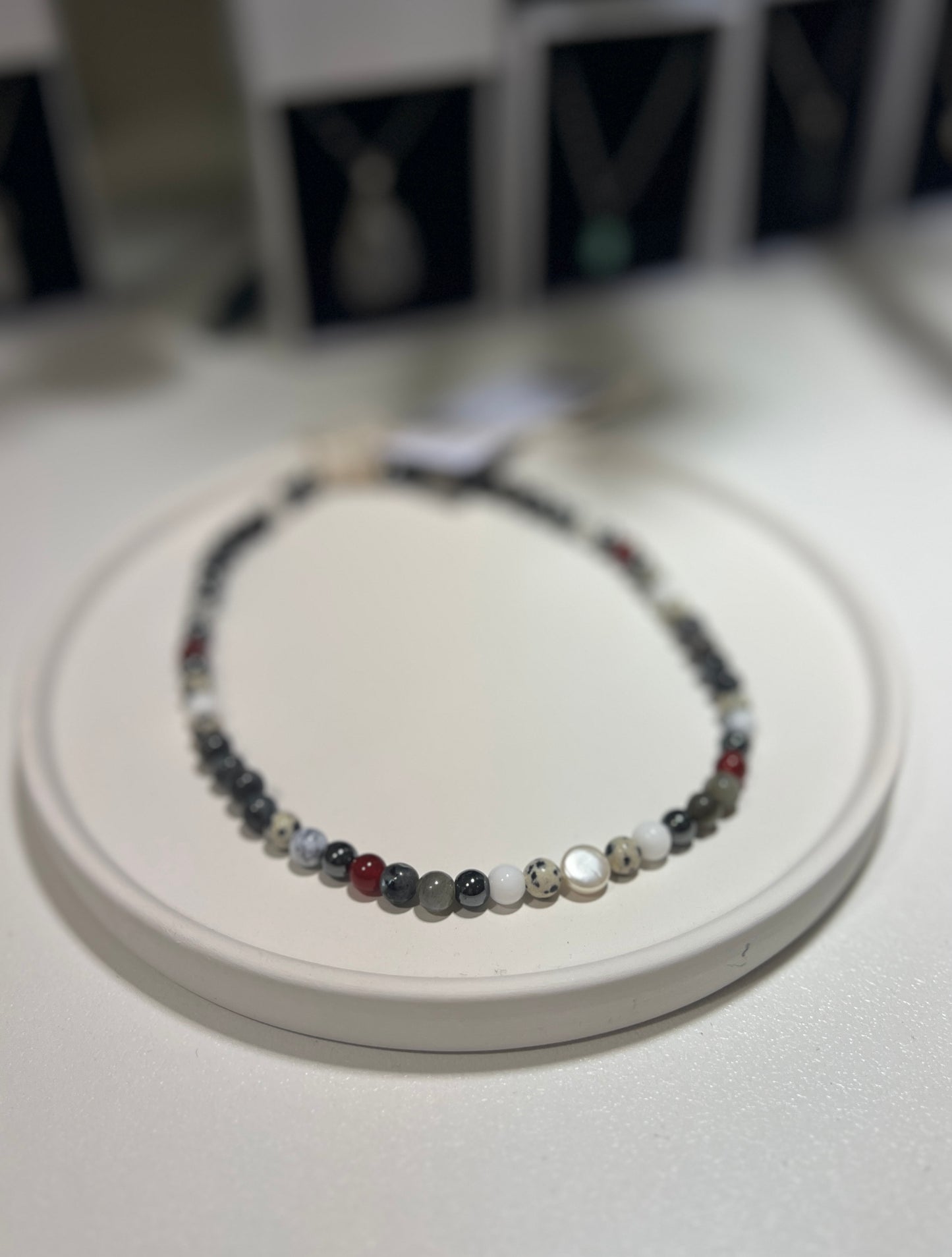 Necklace with multicolored beads on a white surface