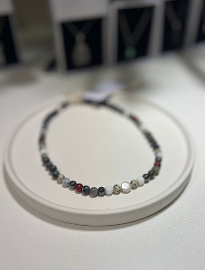 Necklace with multicolored beads on a white surface