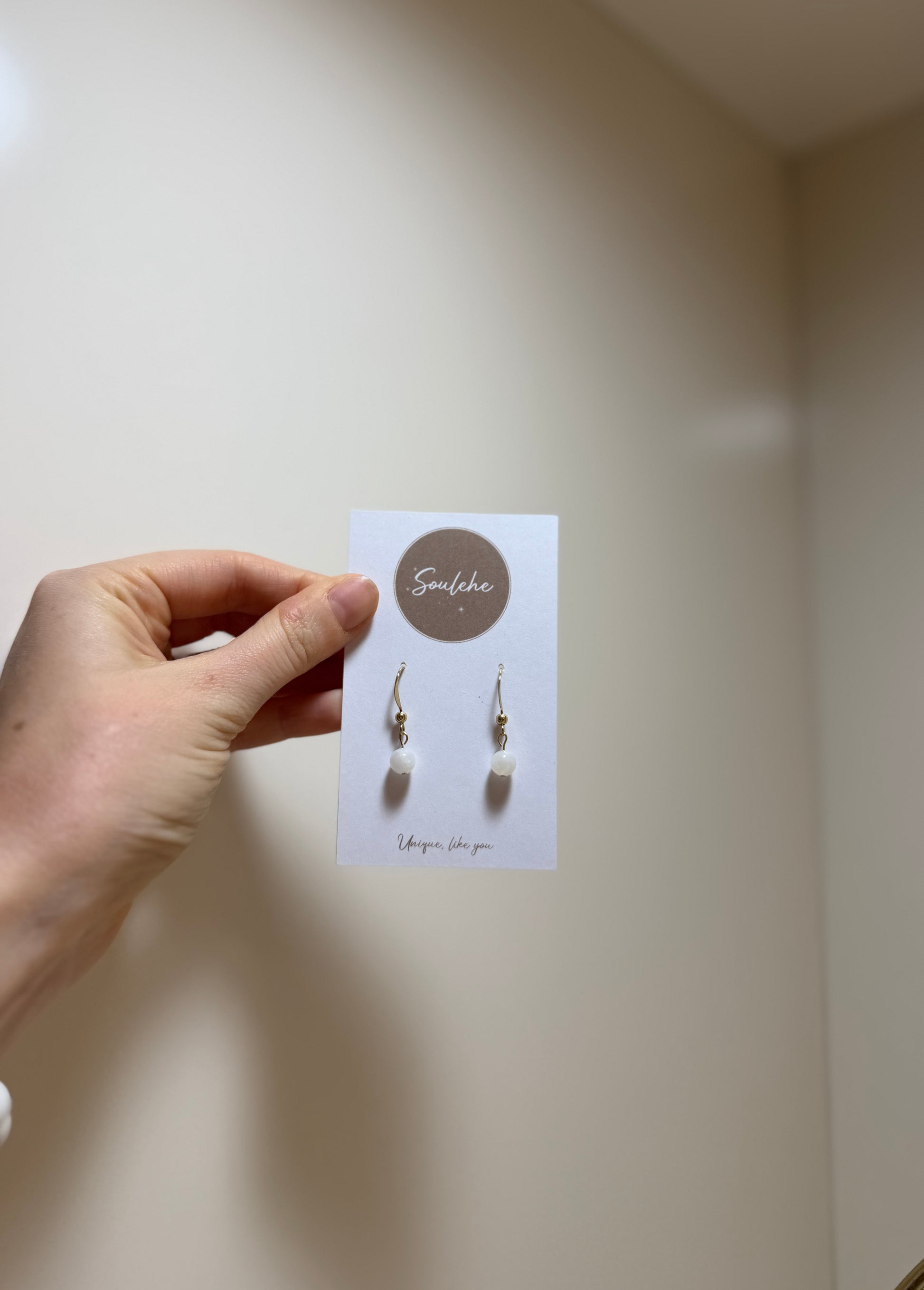 Gold earrings with Moonstone gemstones.