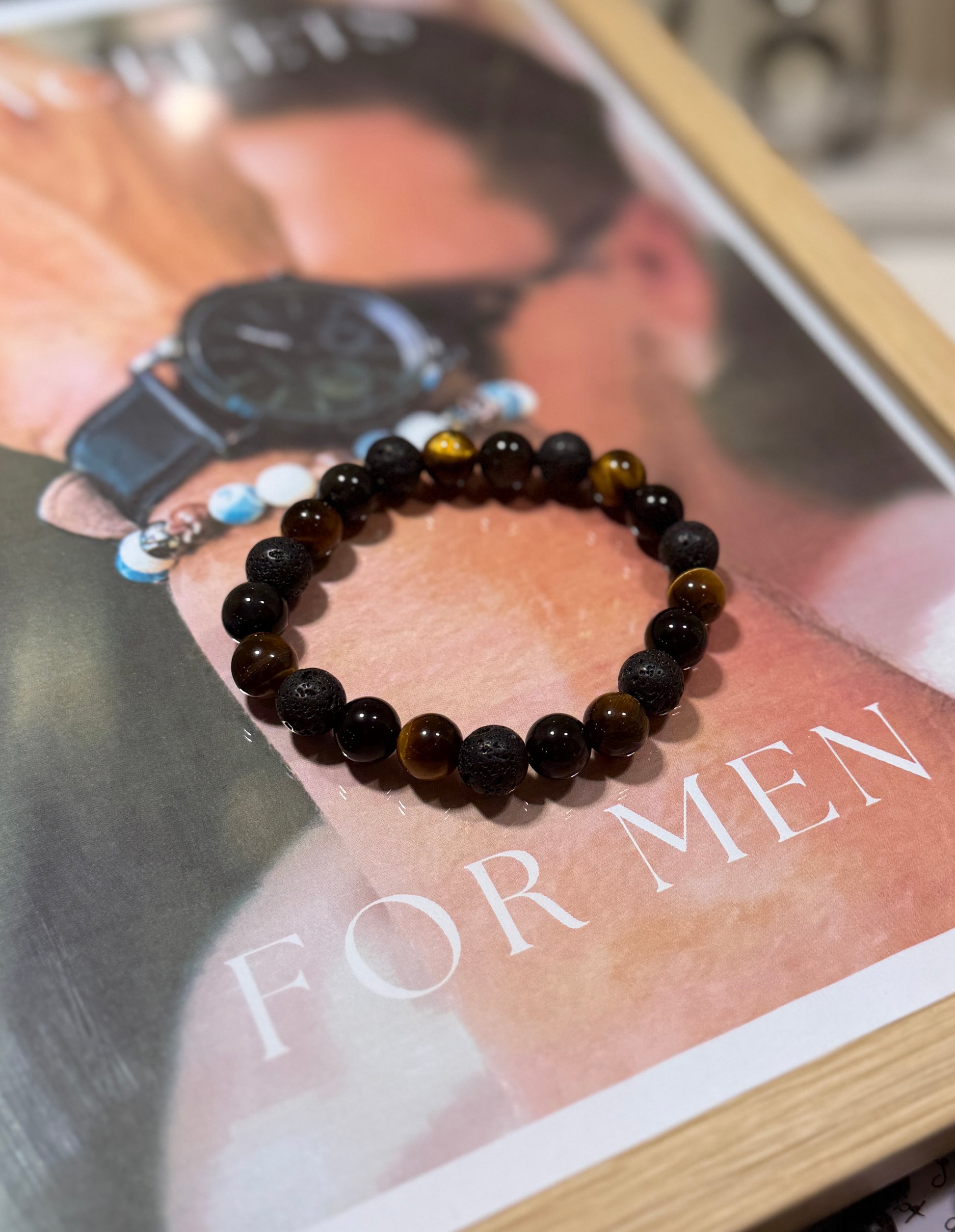 Black beaded bracelet on a mannequin hand with 'For Men' text in the background