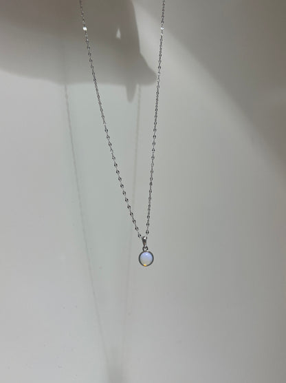 Necklace with a small pendant on a plain background