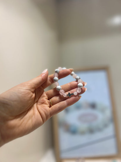 Hand holding a bracelet with a blurred background