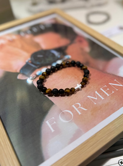 Black beaded bracelet on a magazine with 'For Men' text