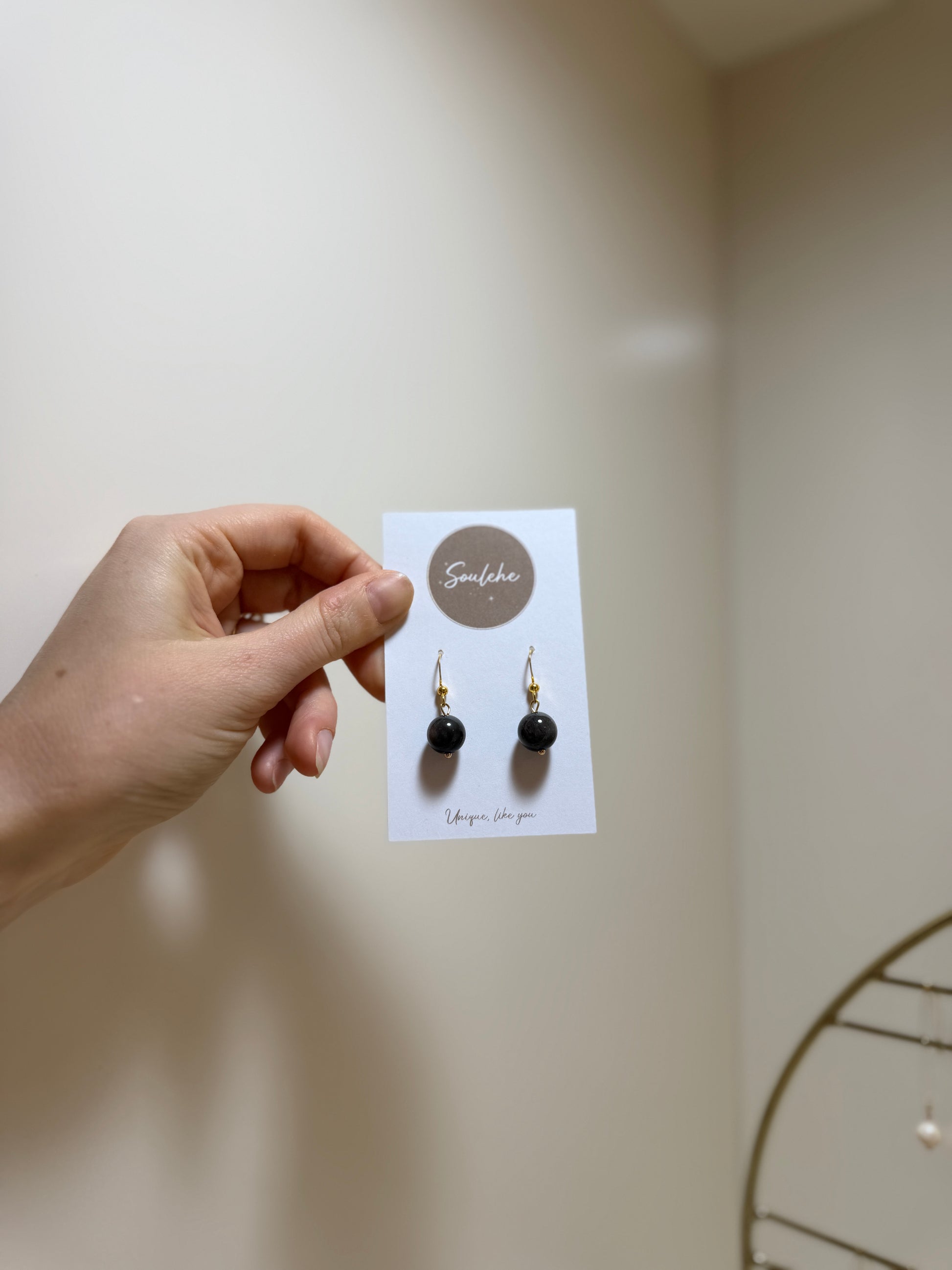 Gold hook earrings with Obsidian beads.