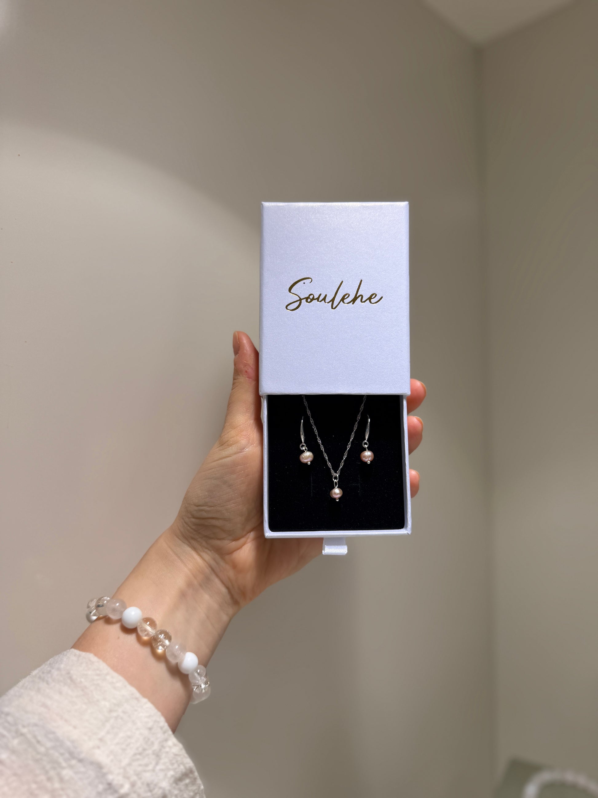 Pink pearl silver necklace with matching pink pearl earrings.