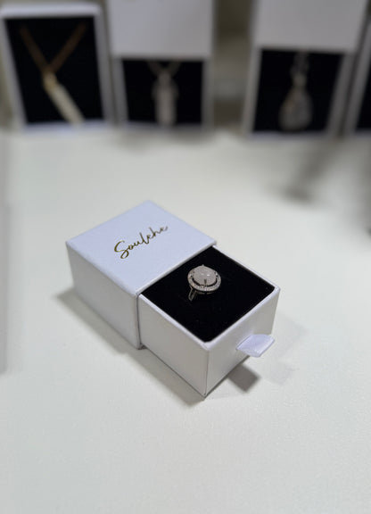 Jewelry box with a ring inside on a white surface