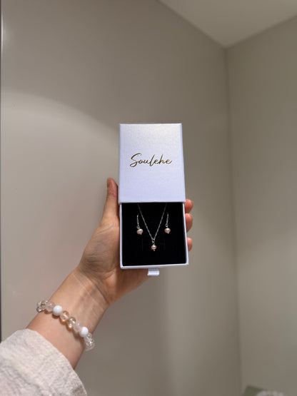 Pink pearl silver necklace with matching pink pearl earrings.