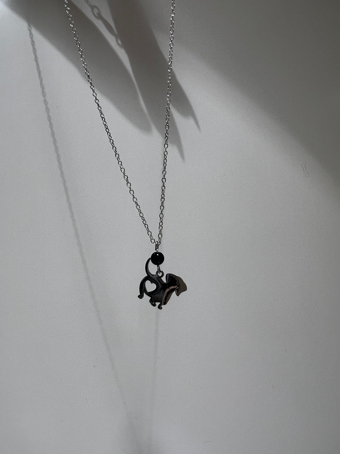 Necklace with a black pendant on a white background