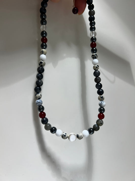 Necklace with multicolored beads on a white background